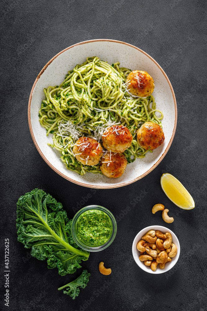 Canvas Prints Chicken meatballs with spaghetti and green kale cashew pesto sauce, top view