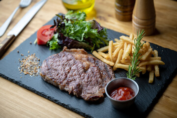 beef steak with salad and french fries