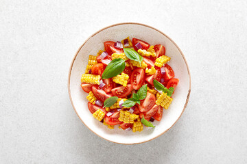 Tomato and corn salad with fresh basil and red onion