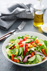 Vegetarian fresh vegetable organic salad with cucumber, red bell pepper, red onion, corn and green lettuce