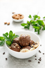 Chocolate and banana fruit ice cream with almond nuts served in bowls