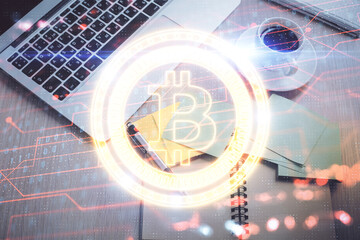 Blockchain theme hologram drawings over computer on the desktop background. Top view. Double exposure.