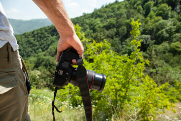 photographer holding camera in nature