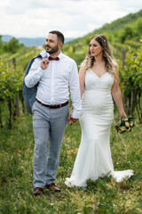 Wedding bride and groom man and woman walking in the field celebrating happy after the marriage ceremony togetherness bonding and love concept full length