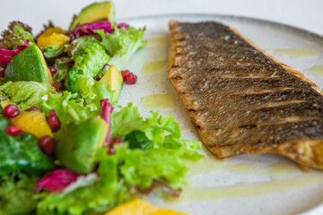 dish grilled fish vegetables avocado salad orange