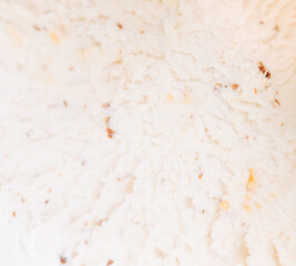 Top view of vanilla ice cream with chocolate chip cookies, chocolate chips and caramel sauce.	