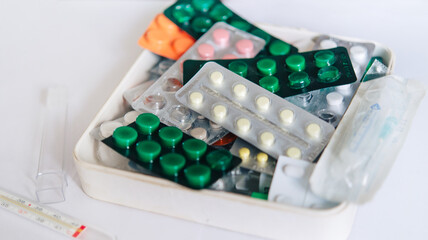 bunch of medical pills in white, pink, green and other colors. Tablets in plastic packaging. Health care and medicine concept. Pharmaceutical industry concept.