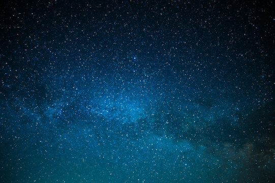 Milky Way. A beautiful night sky with bright stars sparkling. Beautiful shades of blue. Minimalism. No people. Background. Texture, wallpaper. There is a place for your insert.
