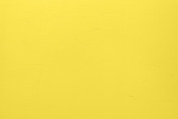 Saturated yellow colored low contrast Concrete textured background with roughness and...