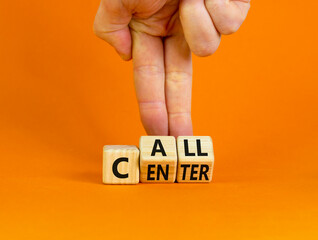 Call center symbol. Businessman turns wooden cubes with words 'Call center'. Beautiful orange background. Call center and business concept. Copy space.