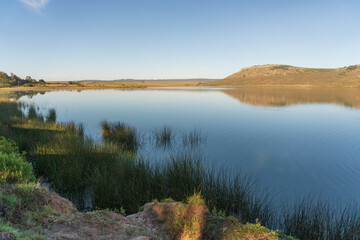 Small lagoon at the foot of the mountain ranges in the countryside of Argentina
