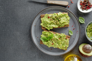 Tasty fresh toast with mashed avocado
