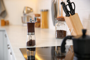 Manual coffee grinder on countertop in kitchen