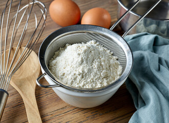bowl and flour strainer on kitchen table