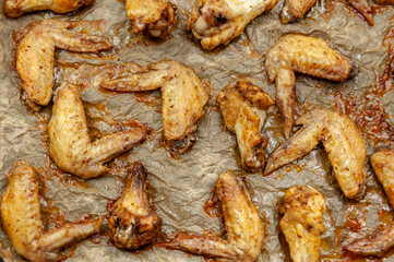 Hot and Spicey Buffalo Chicken Wings. Cooked chicken wings on parchment paper. Top view