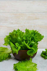 fresh lettuce leaves in a clay bowl, the concept of food, healthy nutrition, healthy greens, ingredient for a menu