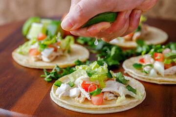 Squeezing the lime juice over a taco.