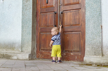 child pulling on the door