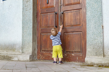 child pulling on the door