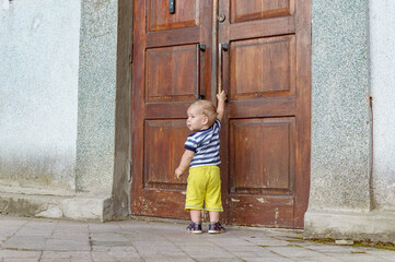 child pulling on the door