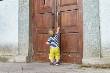 Fototapeta na wymiar child pulling on the door