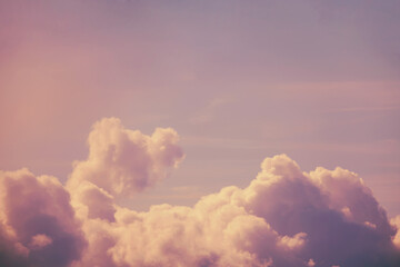 Pink clouds in a blue sky, copy space for text