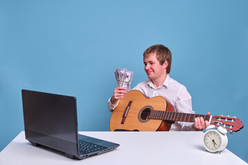 Music teacher at the computer with money on a blue background, remote music lessons and salary in dollars
