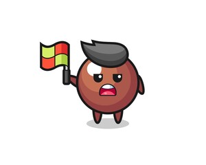 chocolate ball character as line judge putting the flag up