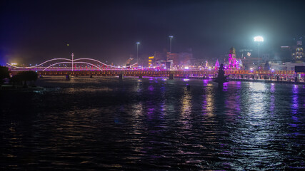 Beautiful Night View of Haridwar city during largest Indian festival Kumbh Mela. Bank of Ganga River is lit up with lights. The Holy River of India. High quality 4k footage