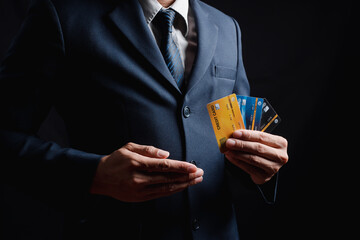 Businessman wearing a hardhat standing at goods warehouse and check control loading from Cargo freight ship for import and export by the report by smartphone. commercial warehouse for trading concept