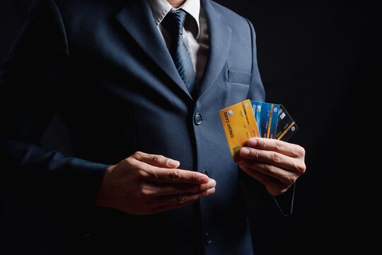 Businessman wearing a hardhat standing at goods warehouse and check control loading from Cargo freight ship for import and export by the report by smartphone. commercial warehouse for trading concept