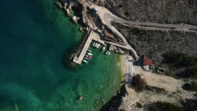 Down shot birds eye with drone in Luka Croatia coast clear sea and harbor with boats majestic  view