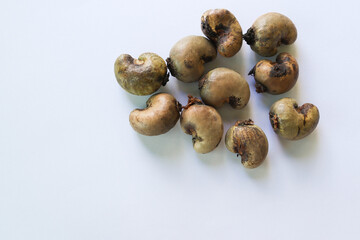 Cashew nut (Anacardium occidentale) pile, old fruits isolated on white background closeup.