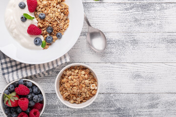 Healthy breakfast with baked granola and greek yogurt. Assorted fresh berries