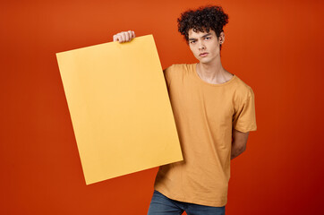 guy with curly hair holding an island in his hands advertising