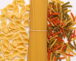 dry raw spaghetti conchiglie seashells fusilli cork screw color pasta on white background