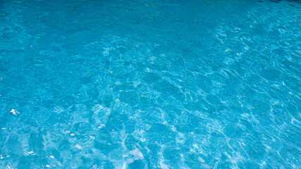 Obraz premium Abstract pool water. Swimming pool bottom caustics ripple and flow with waves background surface of blue swimming pool
