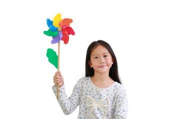 Obraz na płótnie Canvas Asian little girl child holding colorful pinwheel isolated on white background