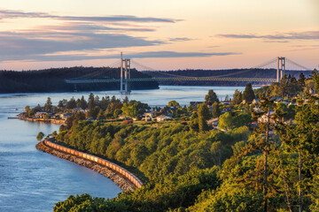 Tacoma Narrows Bridge taken from the south with a train headed north during a sunset