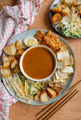 Popular Indian gourmet in Malaysia / Rojak or Pasembur / Fried dough shrimp fritters, tofu, egg, spicy cuttlefish, shredded cucumber, turnip and bean sprouts in thick and spicy peanut gravy sauce