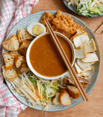 Popular Indian gourmet in Malaysia / Rojak or Pasembur / Fried dough shrimp fritters, tofu, egg, spicy cuttlefish, shredded cucumber, turnip and bean sprouts in thick and spicy peanut gravy sauce