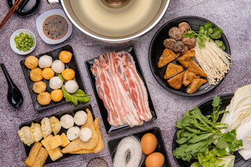 Chinese Hot pot, also known as soup-food or steamboat, is a cooking method that originates from China, prepared with a simmering pot of soup stock at the dining table - obrazy, fototapety, plakaty