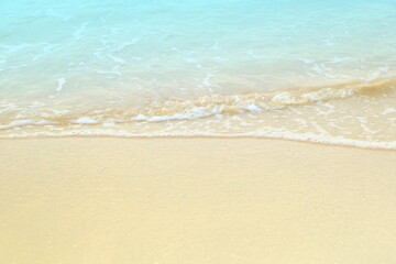 Fototapeta na wymiar Soft white blue sea wave on clean brown sandy beach coast have copyspace
