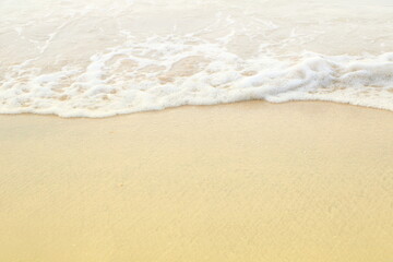 Fototapeta na wymiar Soft white sea wave on clean brown sandy beach coast have copyspace