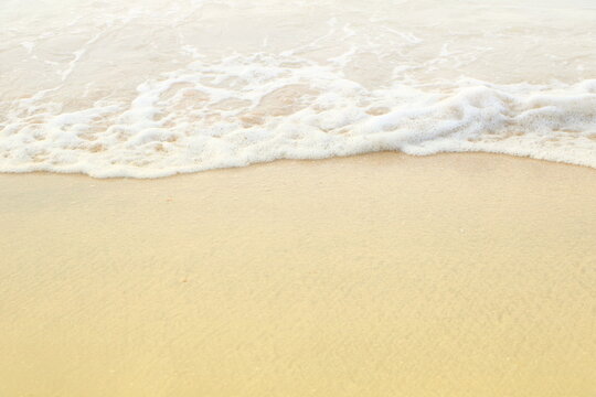 Soft white sea wave on clean brown sandy beach coast have copyspace