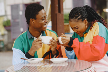 Ethnic couple sitting in the summer cafe