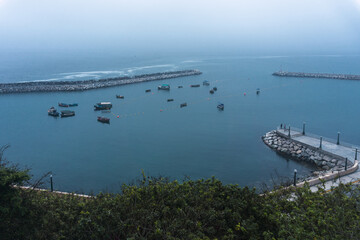 Chorrillos dock in Lima Peru, several fisher boats and breakwater