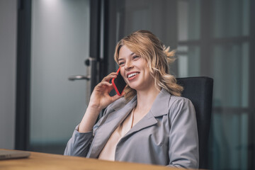 Smiling business woman talking on smartphone
