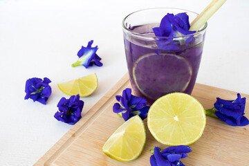 herbal health drinks butterfly pea, lemon with flowers arrangement flat lay style on background...