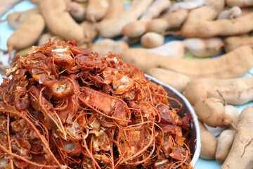 Close up details of ripe sour brown tamarind pile peeled tamarind seeds for make soggy tamarind, have copyspace